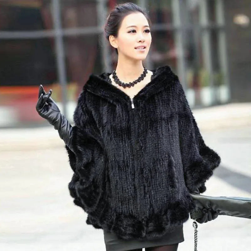 Woman wearing a black fur coat with a blurred background