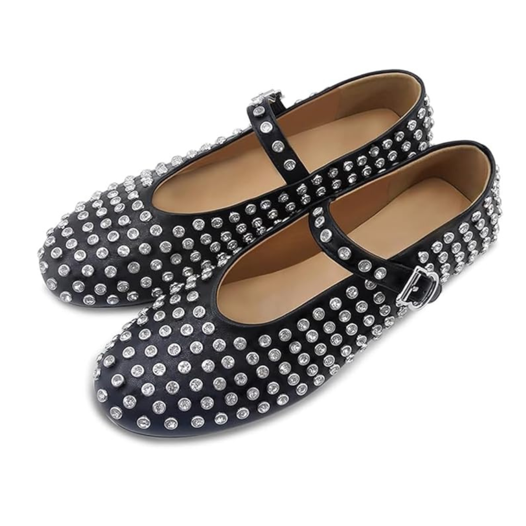 Black flat shoes with silver studs on a white background