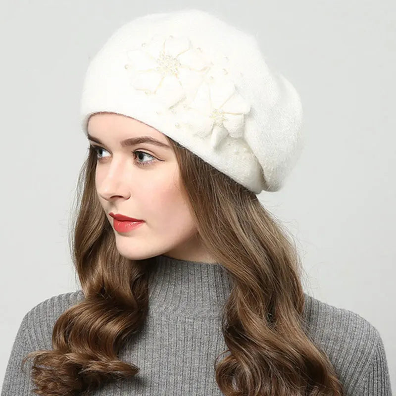 Woman wearing a white knitted hat with a gray background