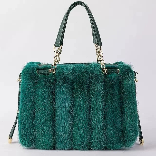 Turquoise fur handbag with gold chain handle on a light gray background, featuring the brand 'QIMING'.