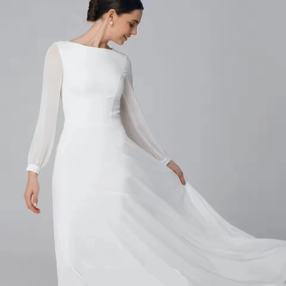 Woman wearing a white long-sleeve dress with a flowing train on a gray background, featuring the brand 'Luxiyiao'.