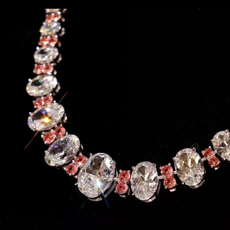 Necklace with large diamonds and smaller stones on a black background