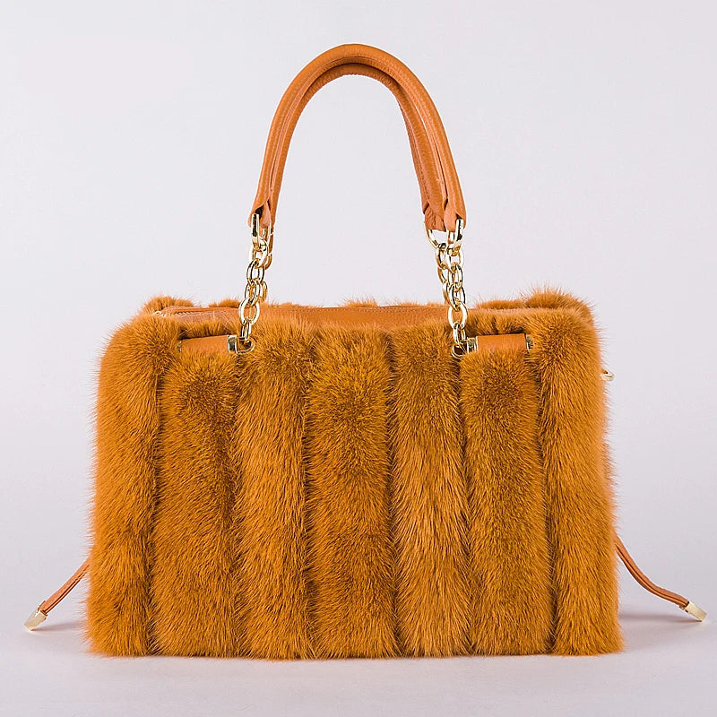 Turquoise fur handbag with gold chain handle on a light gray background, featuring the brand 'QIMING'.