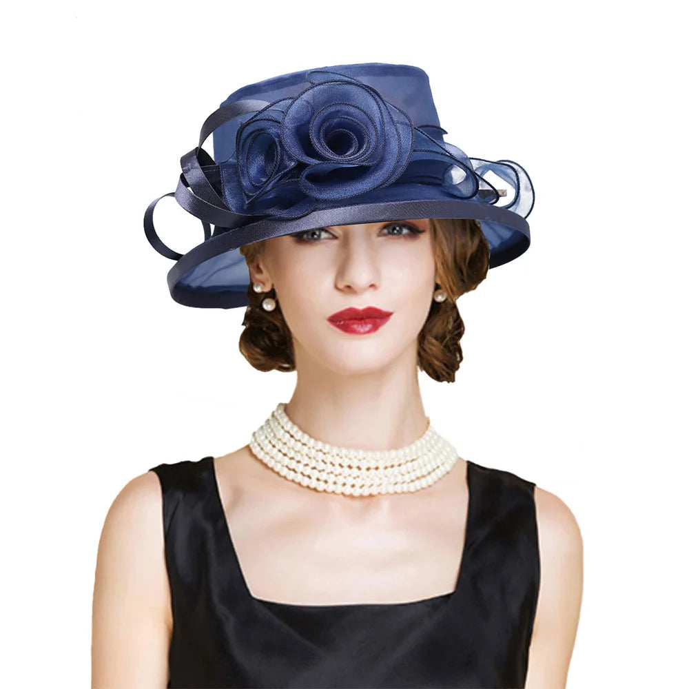 Woman wearing a navy blue hat with floral details on a white background
