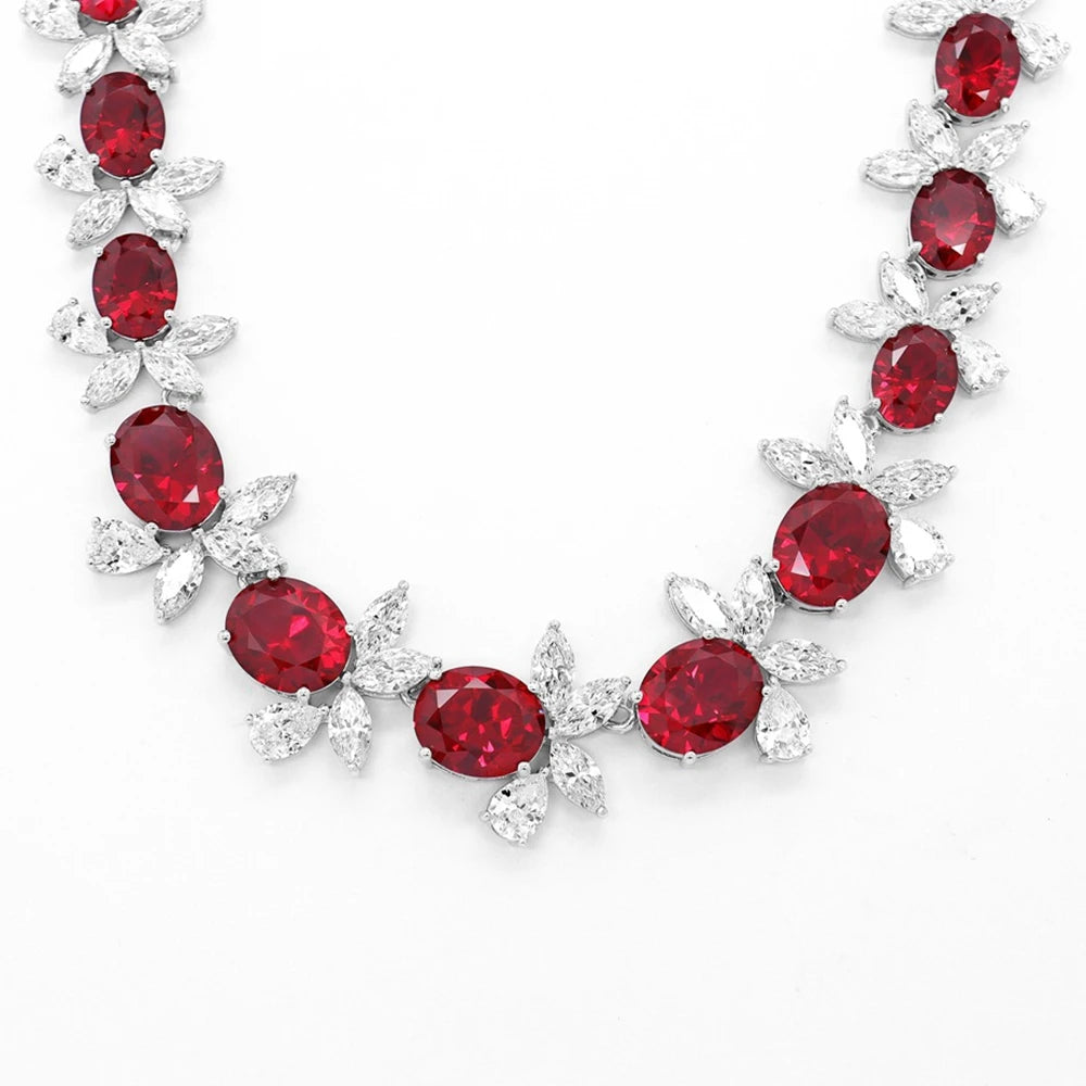 Necklace with red gemstones and silver leaves on a White background