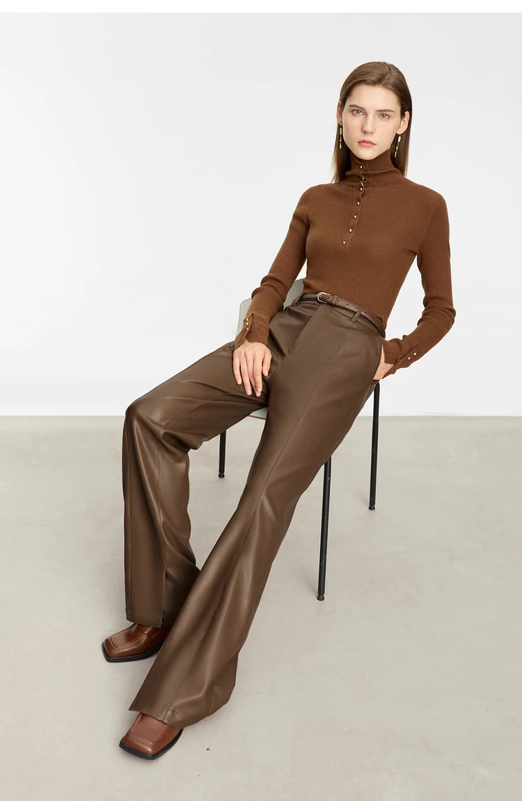 Person wearing black wide-leg pants and a white shirt on a gray background with 'Amii' branding.