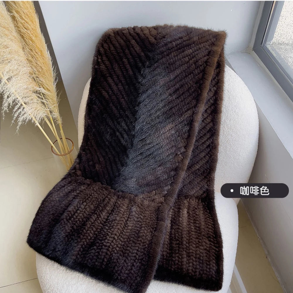 Brown knitted scarf draped over a white chair with a neutral background