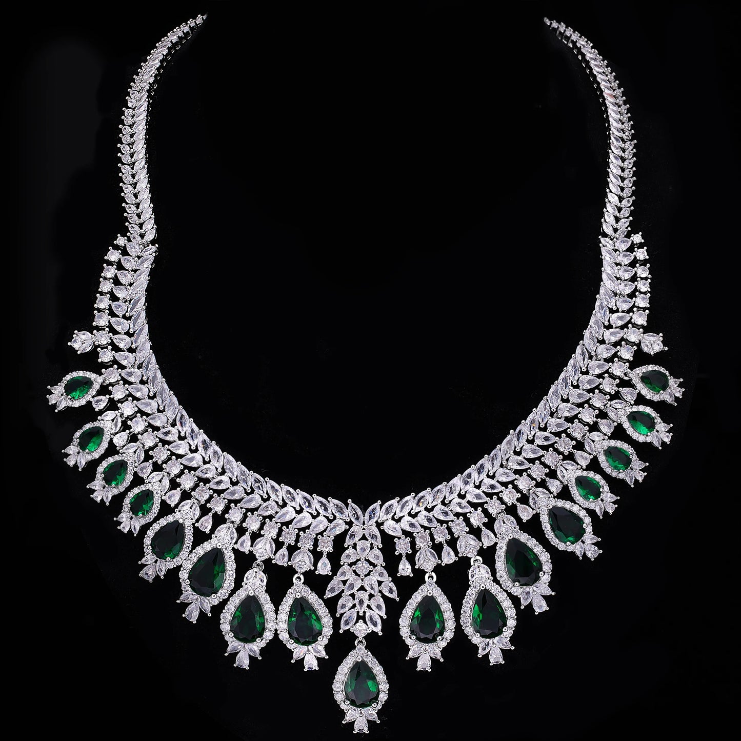 Ornate necklace with green gemstones on a black background