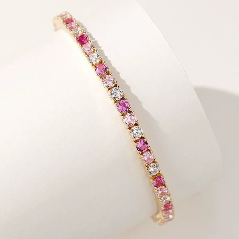 Gold bracelet with pink and White stones on a White background, featuring the wuha brand.