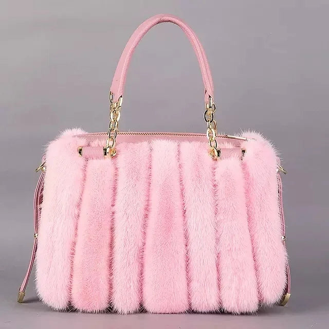 Turquoise fur handbag with gold chain handle on a light gray background, featuring the brand 'QIMING'.