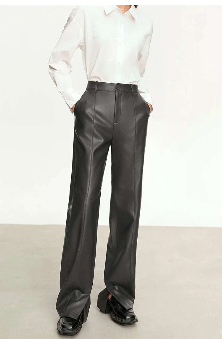 Person wearing black wide-leg pants and a white shirt on a gray background with 'Amii' branding.