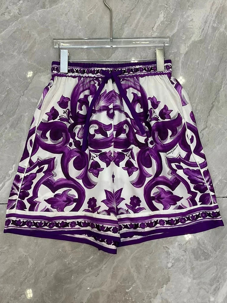 Purple and White patterned shorts on a hanger against a gray marble background