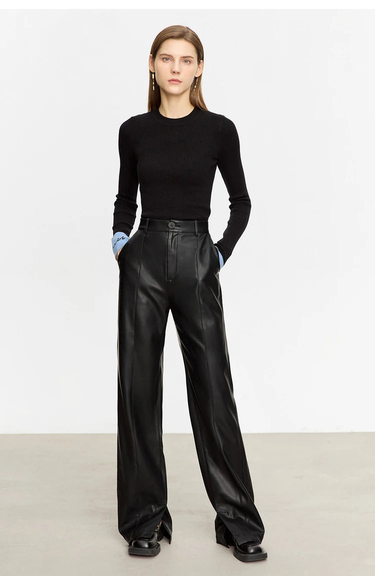 Person wearing black wide-leg pants and a white shirt on a gray background with 'Amii' branding.