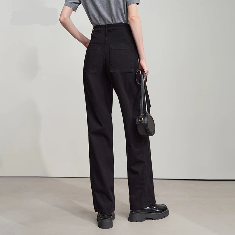 Person wearing black high-waisted pants with a gray top and black shoes on a plain background, featuring the brand 'Amii'.
