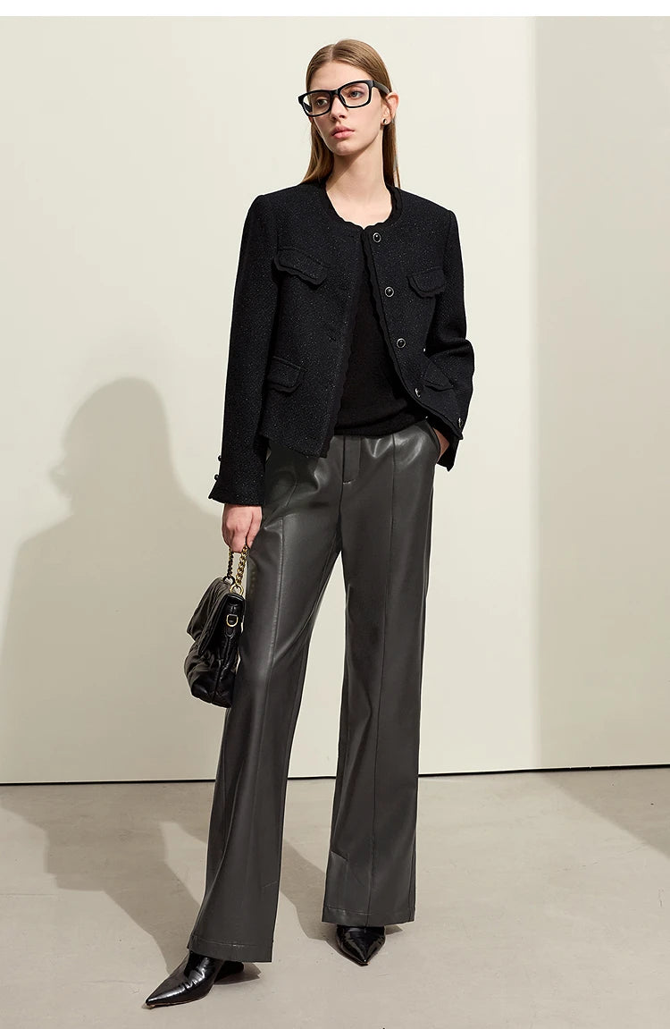 Person wearing black wide-leg pants and a white shirt on a gray background with 'Amii' branding.