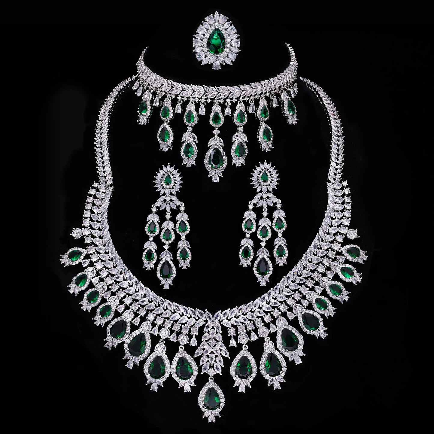 Jewelry set with necklace, earrings, and ring on a black background