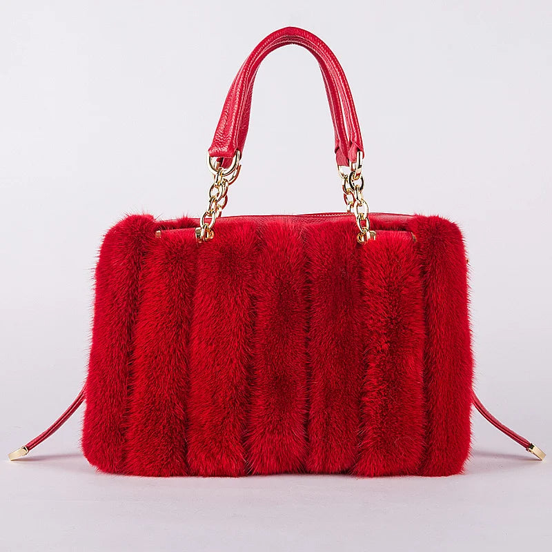 Turquoise fur handbag with gold chain handle on a light gray background, featuring the brand 'QIMING'.