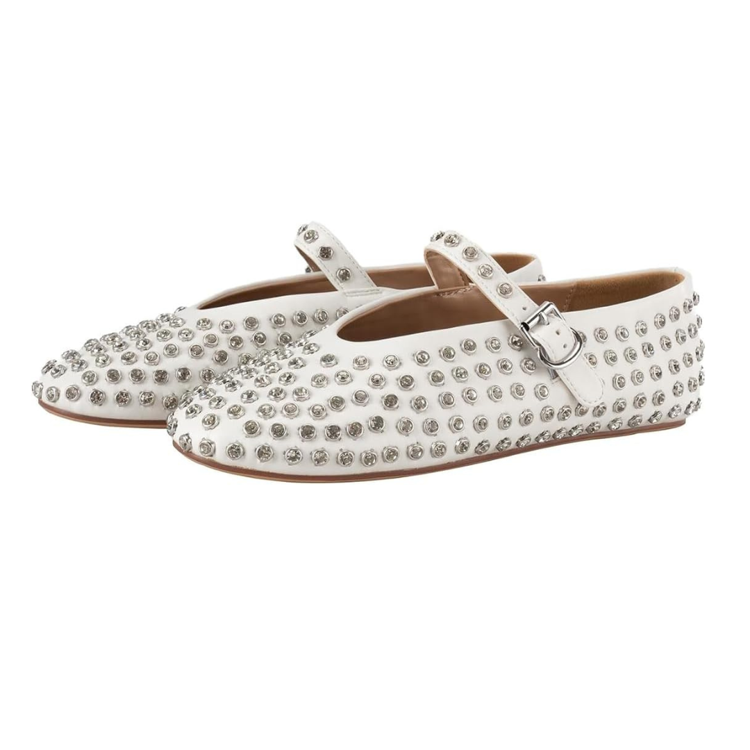 White flats with crystal embellishments on a white background