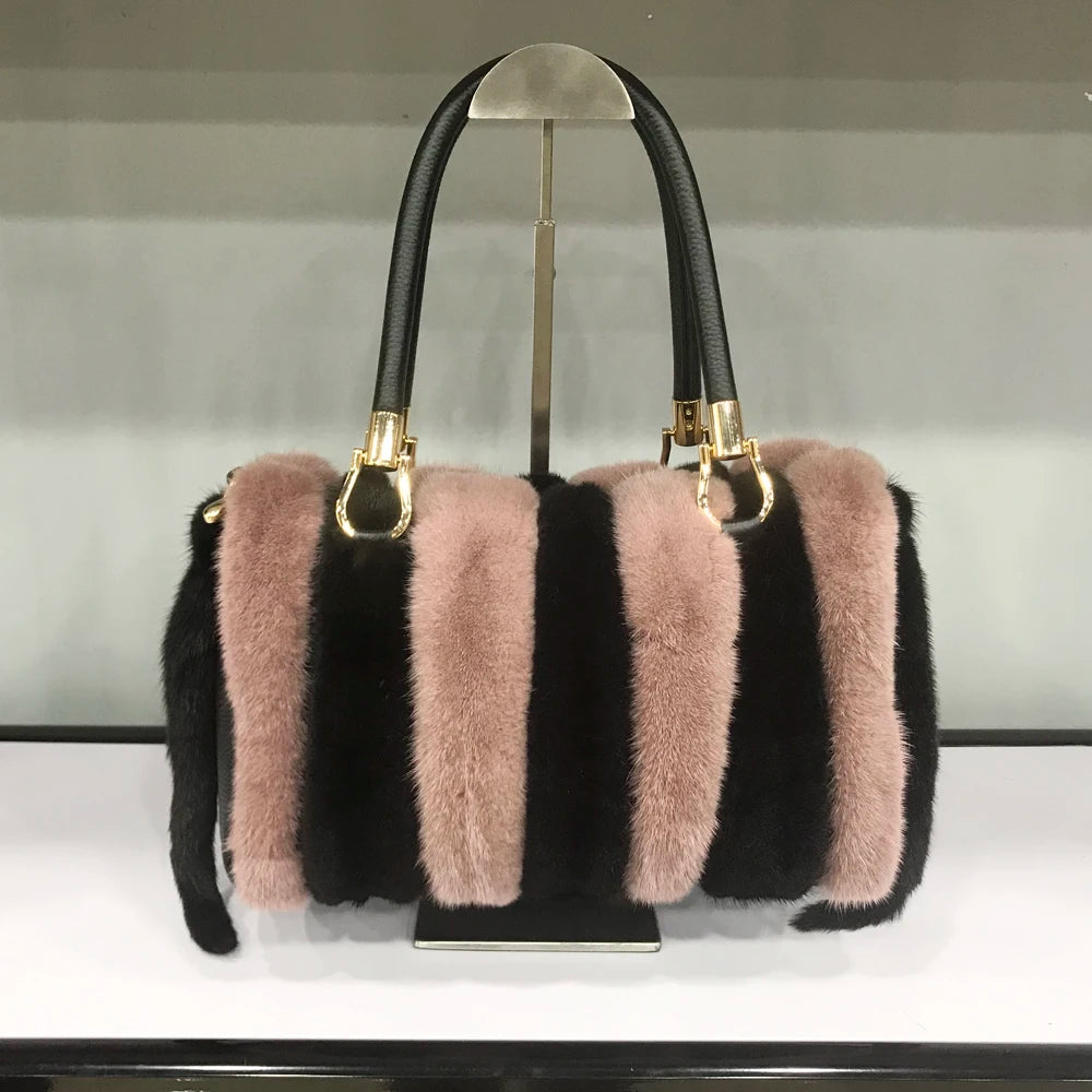 White fur handbag with brown handles on a stand, branded 'LLHPB FUR'.