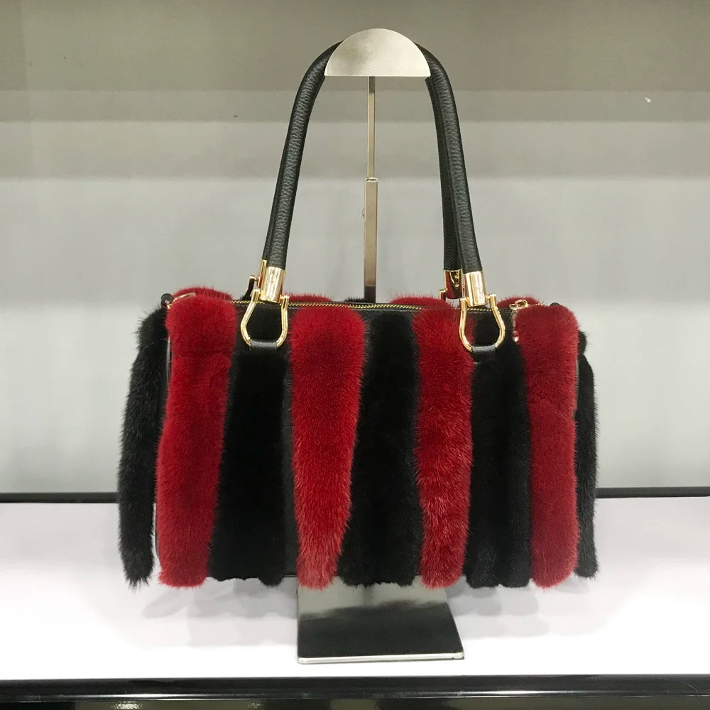 White fur handbag with brown handles on a stand, branded 'LLHPB FUR'.
