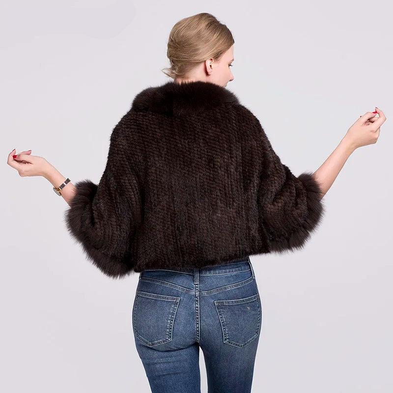 Woman wearing a black fur coat with MS.MinShu branding on a light gray background