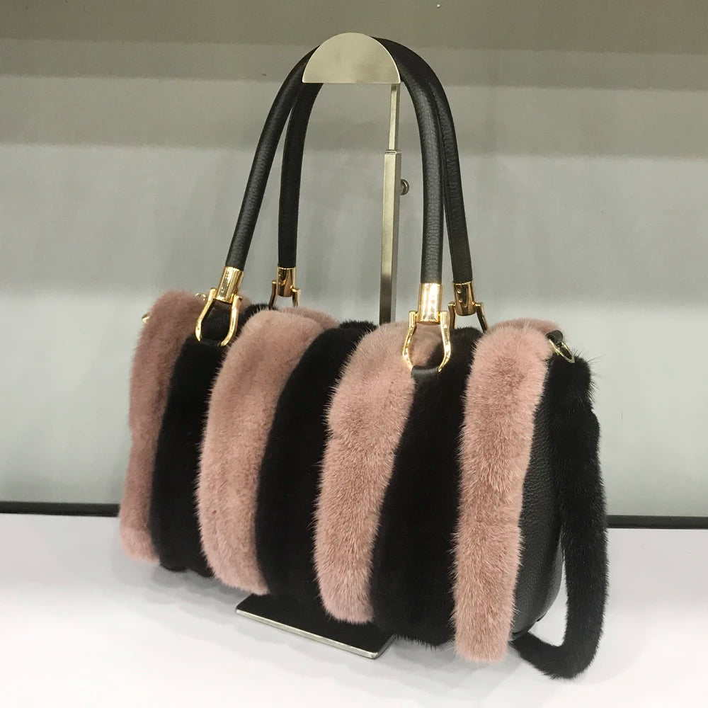 White fur handbag with brown handles on a stand, branded 'LLHPB FUR'.