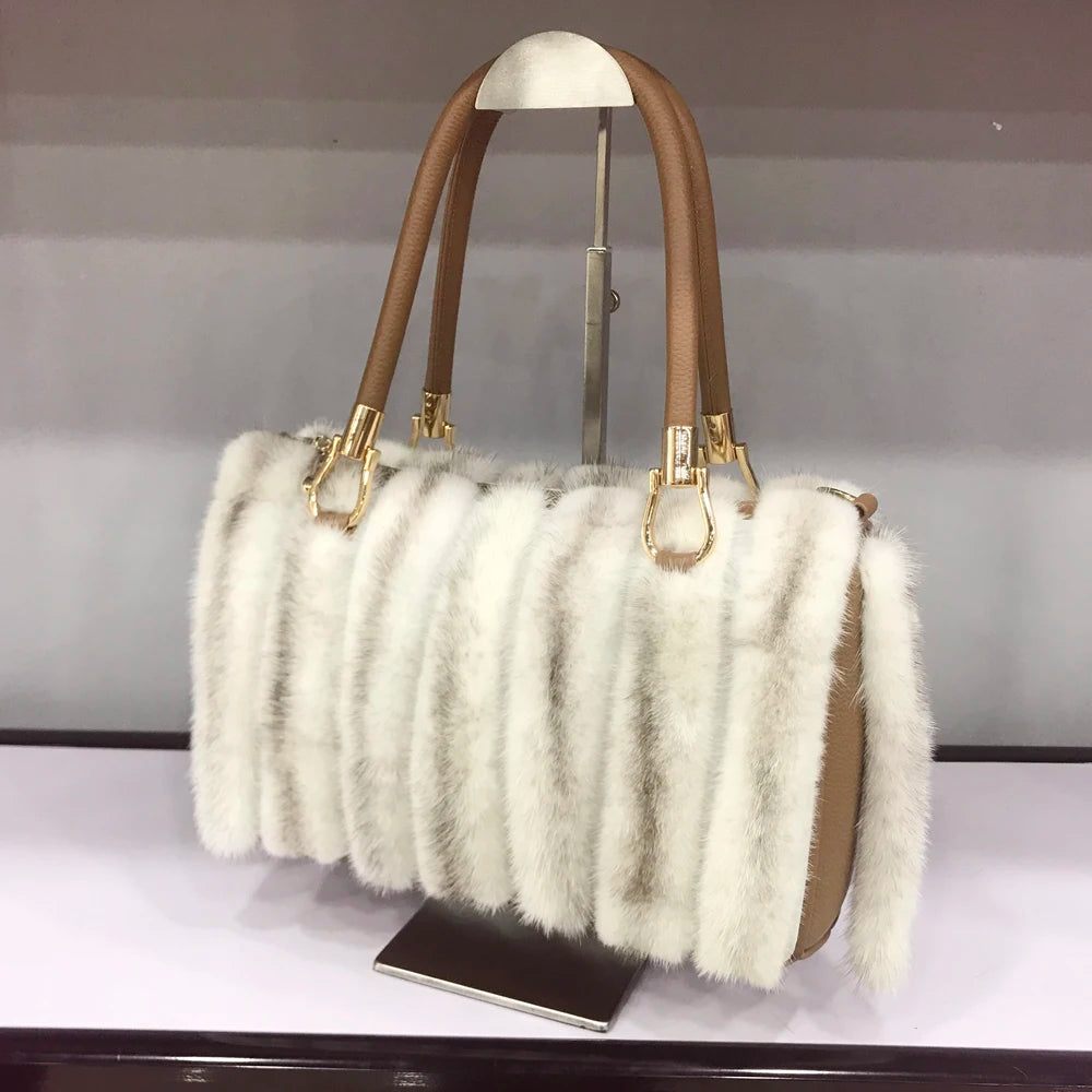 White fur handbag with brown handles on a stand, branded 'LLHPB FUR'.