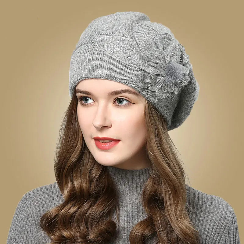 Woman wearing a gray knit hat with a decorative flower on a beige background - HER SHOP