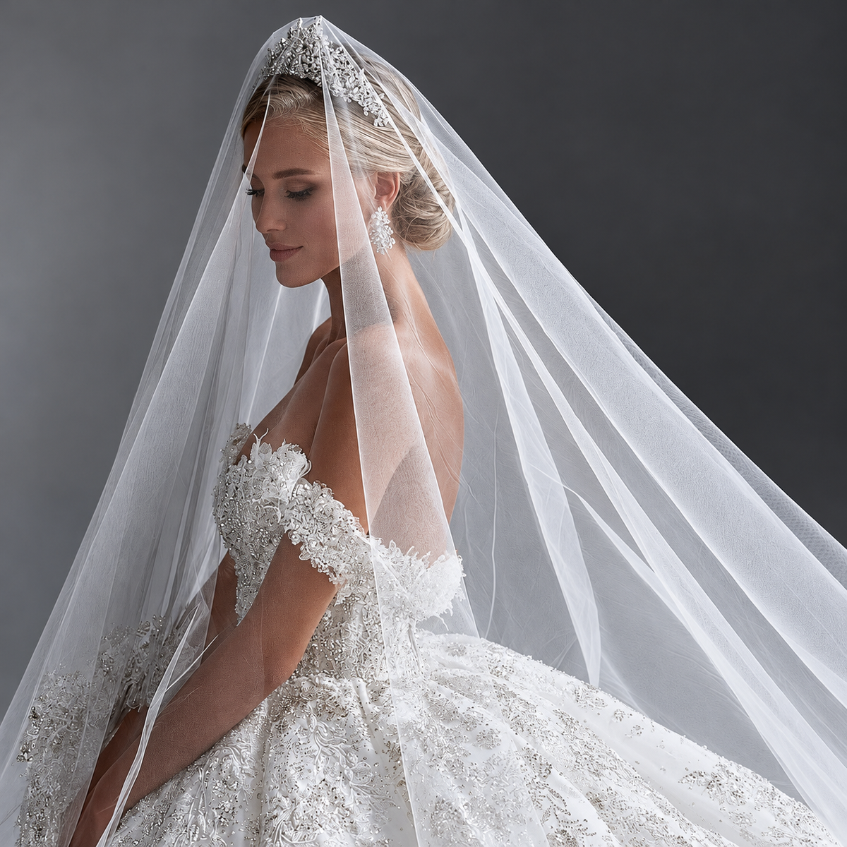 Off-the-shoulder lace ball gown and bridal veil, side portrait