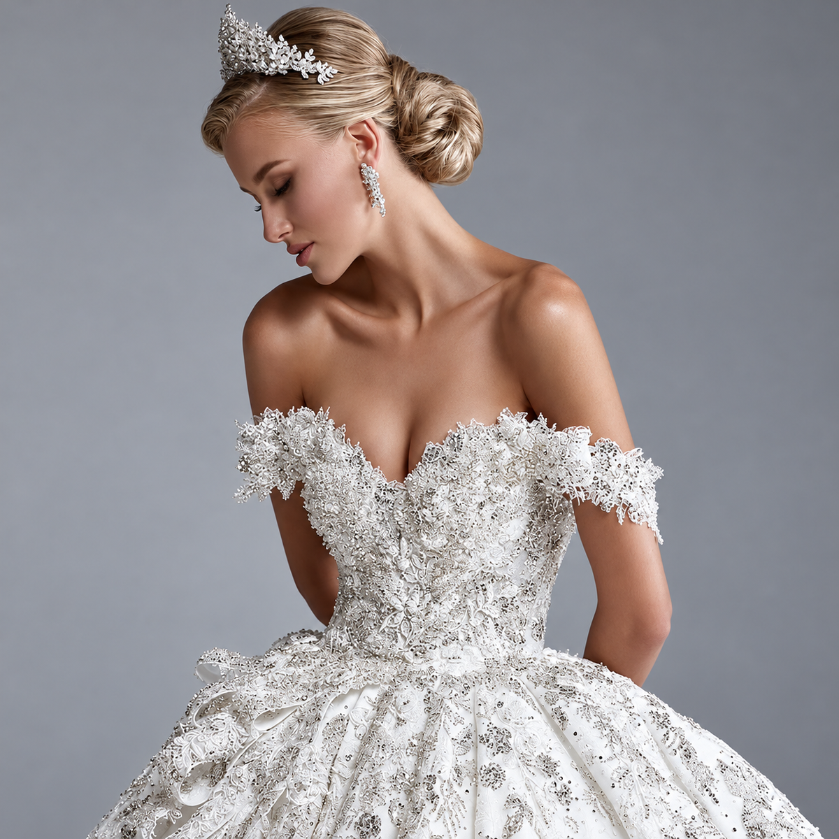 Bride wearing sparkling off-the-shoulder lace ball gown and veil