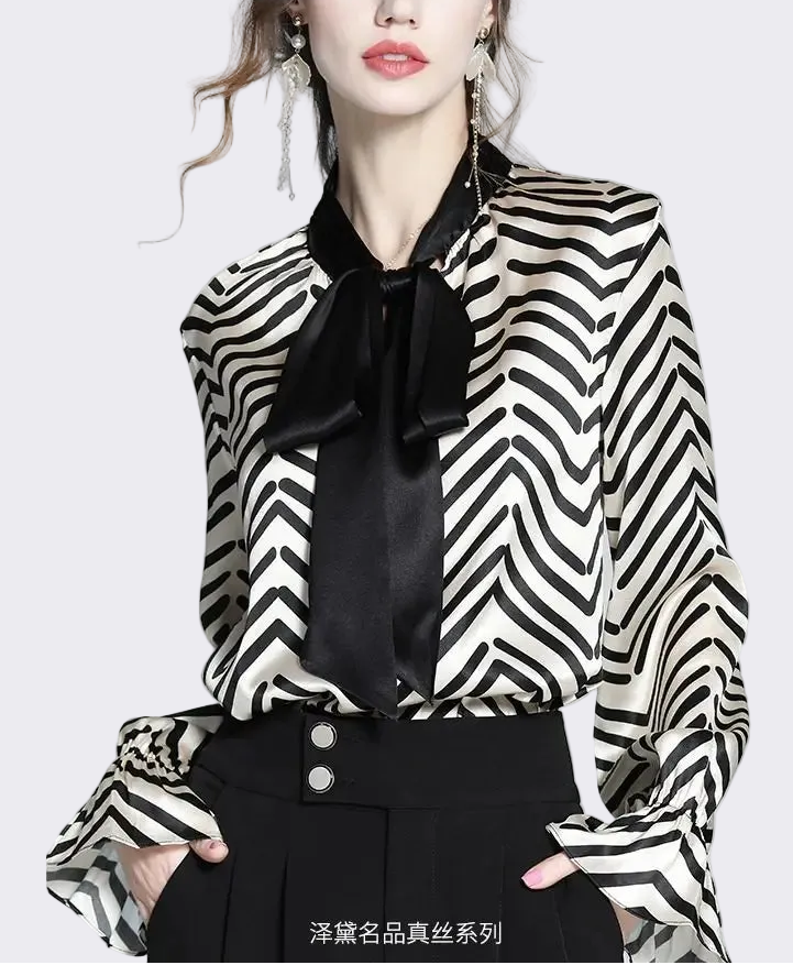 Person wearing a black and white striped blouse with a black bow tie on a gray background - HER SHOP
