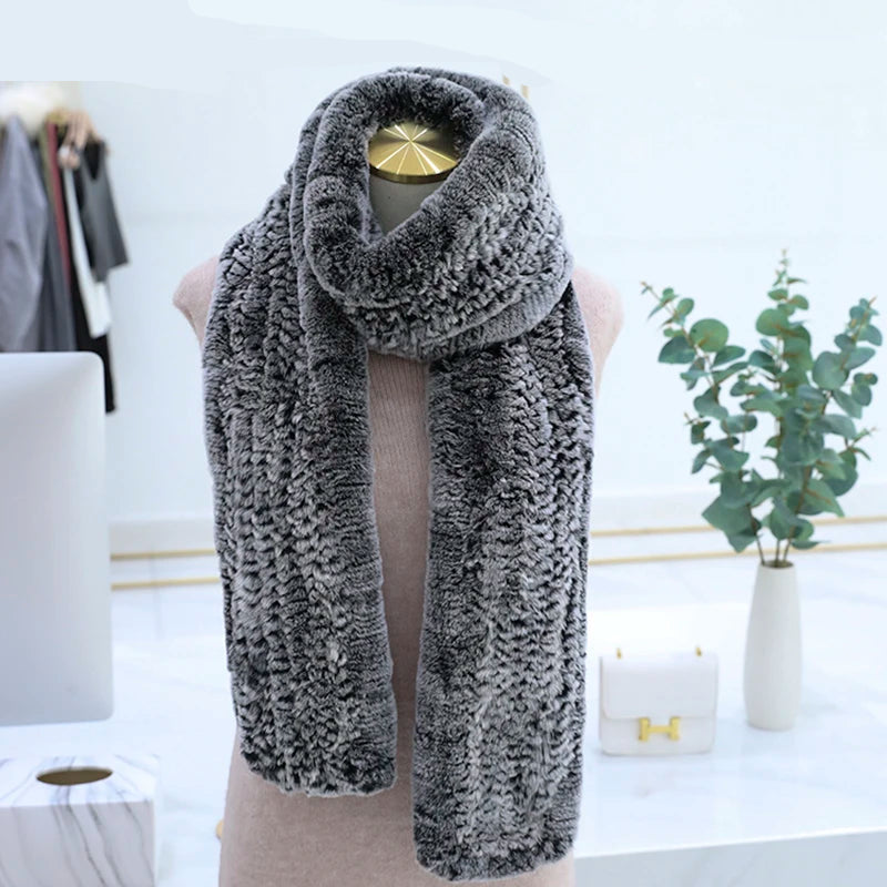 Gray knitted scarf on a mannequin with a blurred indoor background