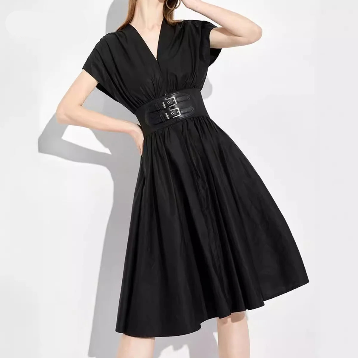 Black dress with a belt on a white background, featuring the brand 'CHCH'.