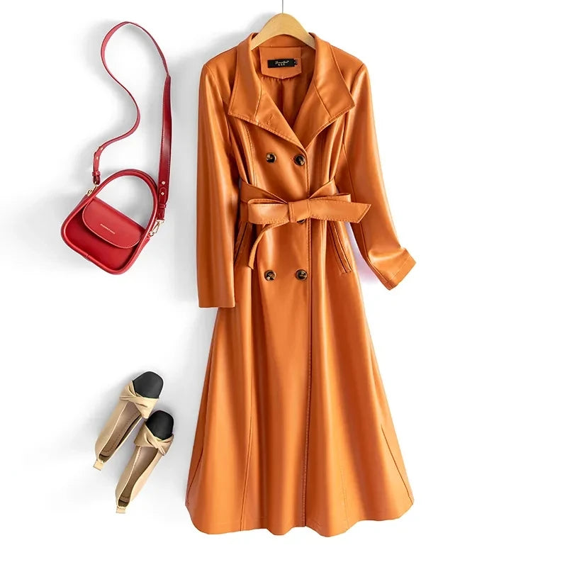 Green leather coat with a brown handbag and black shoes on a white background