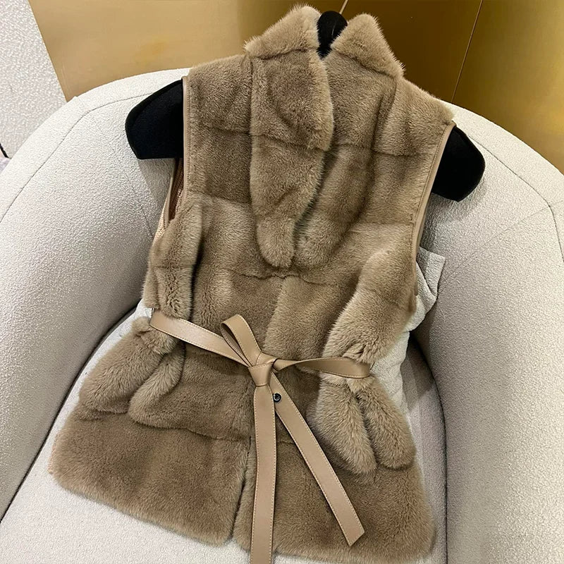 Beige fur vest with a belt on a chair
