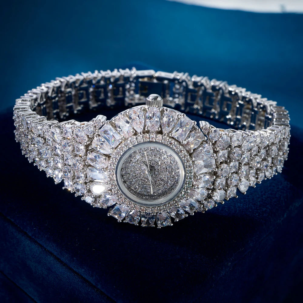 Silver bracelet with diamond accents on a blue velvet background