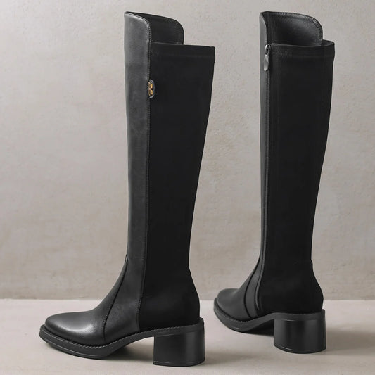 Black knee-high boots on a neutral background - HER SHOP