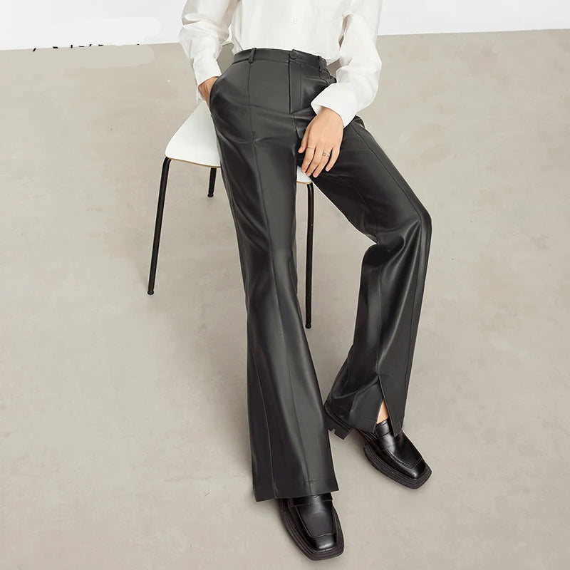 Person wearing black wide-leg pants and a white shirt on a gray background with 'Amii' branding. - HER SHOP