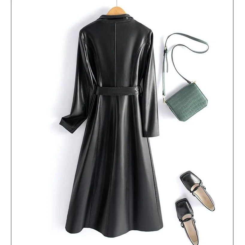 Green leather coat with a brown handbag and black shoes on a white background