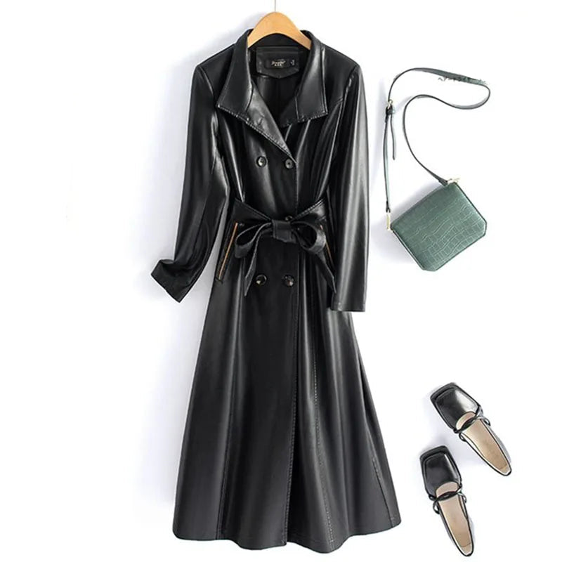 Green leather coat with a brown handbag and black shoes on a white background