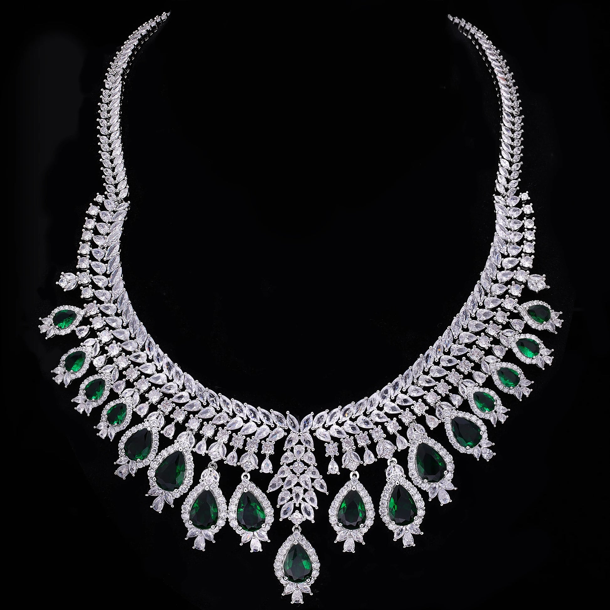 Ornate necklace with green gemstones on a black background