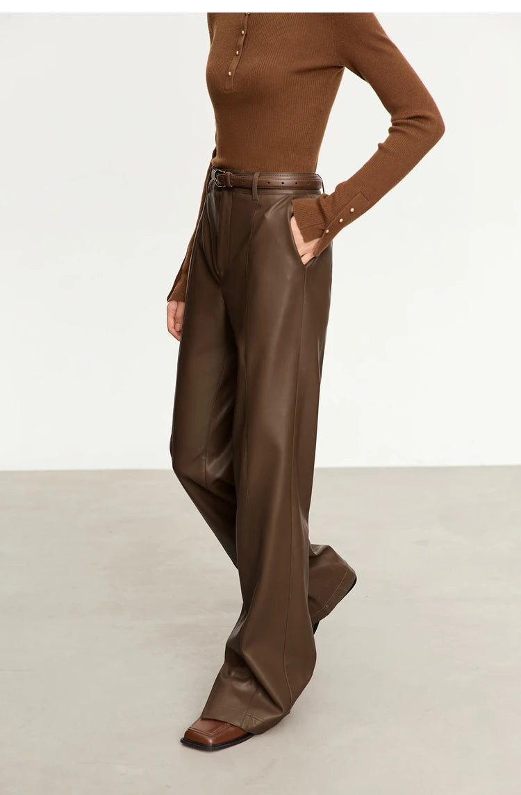Person wearing black wide-leg pants and a white shirt on a gray background with 'Amii' branding.