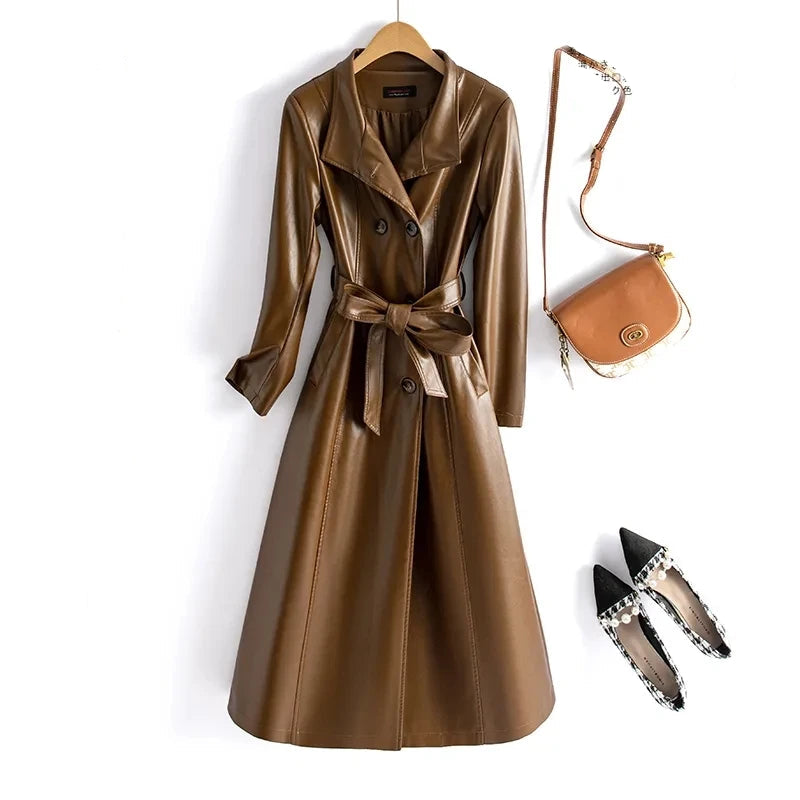 Green leather coat with a brown handbag and black shoes on a white background