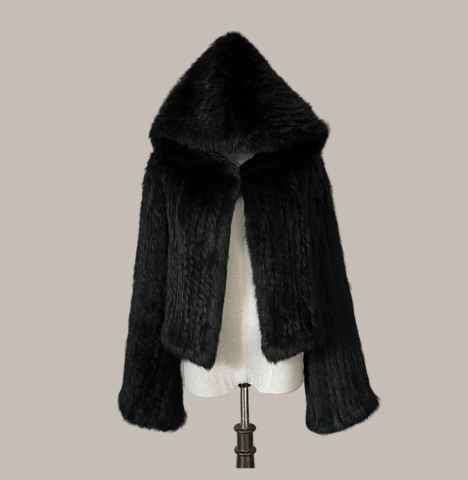 Black fur stole on a mannequin against a decorative background