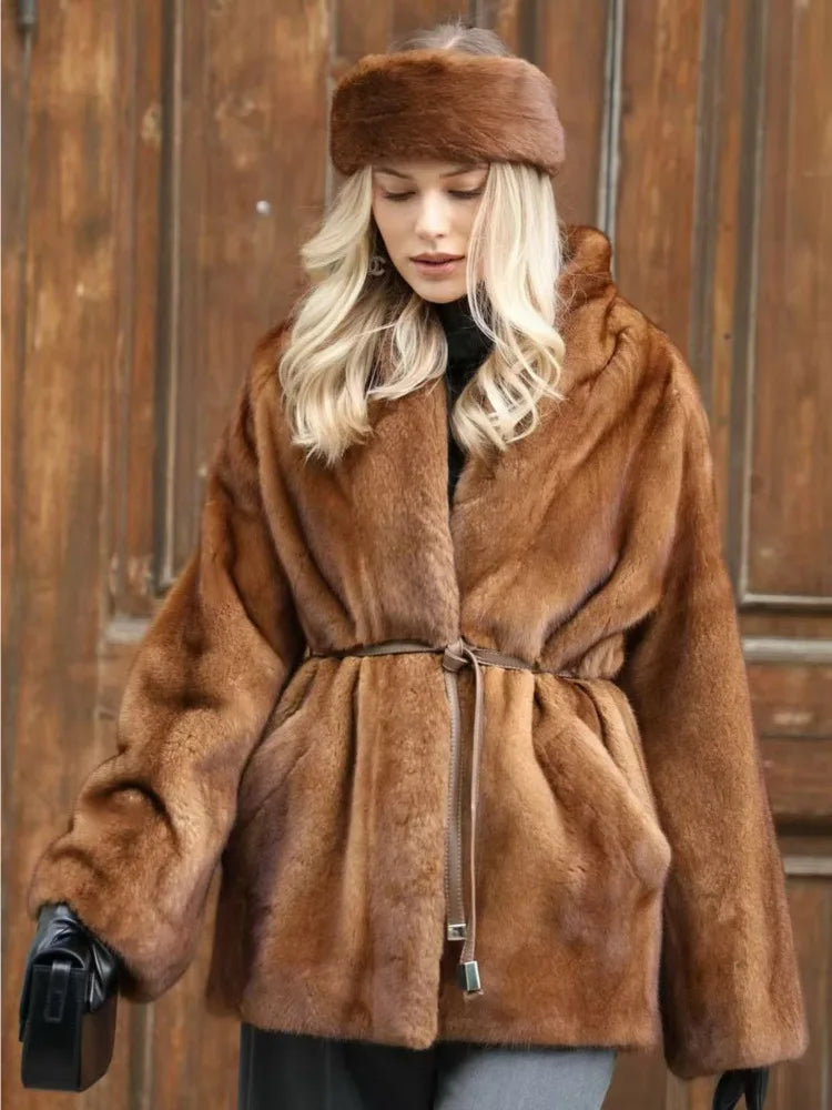 Woman wearing a brown fur coat and hat against a wooden door background