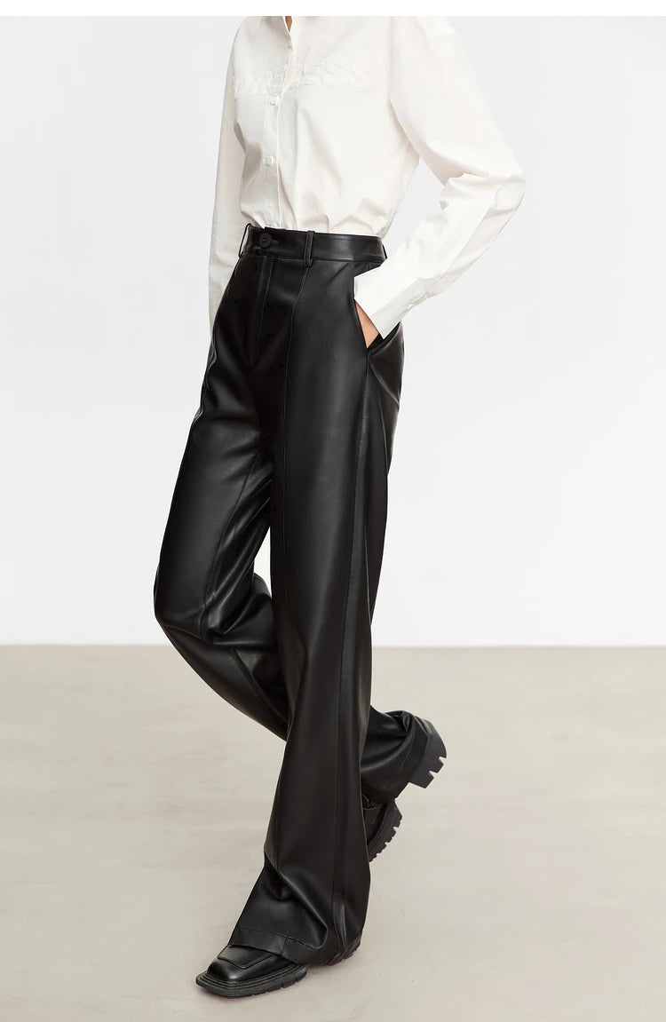 Person wearing black wide-leg pants and a white shirt on a gray background with 'Amii' branding.