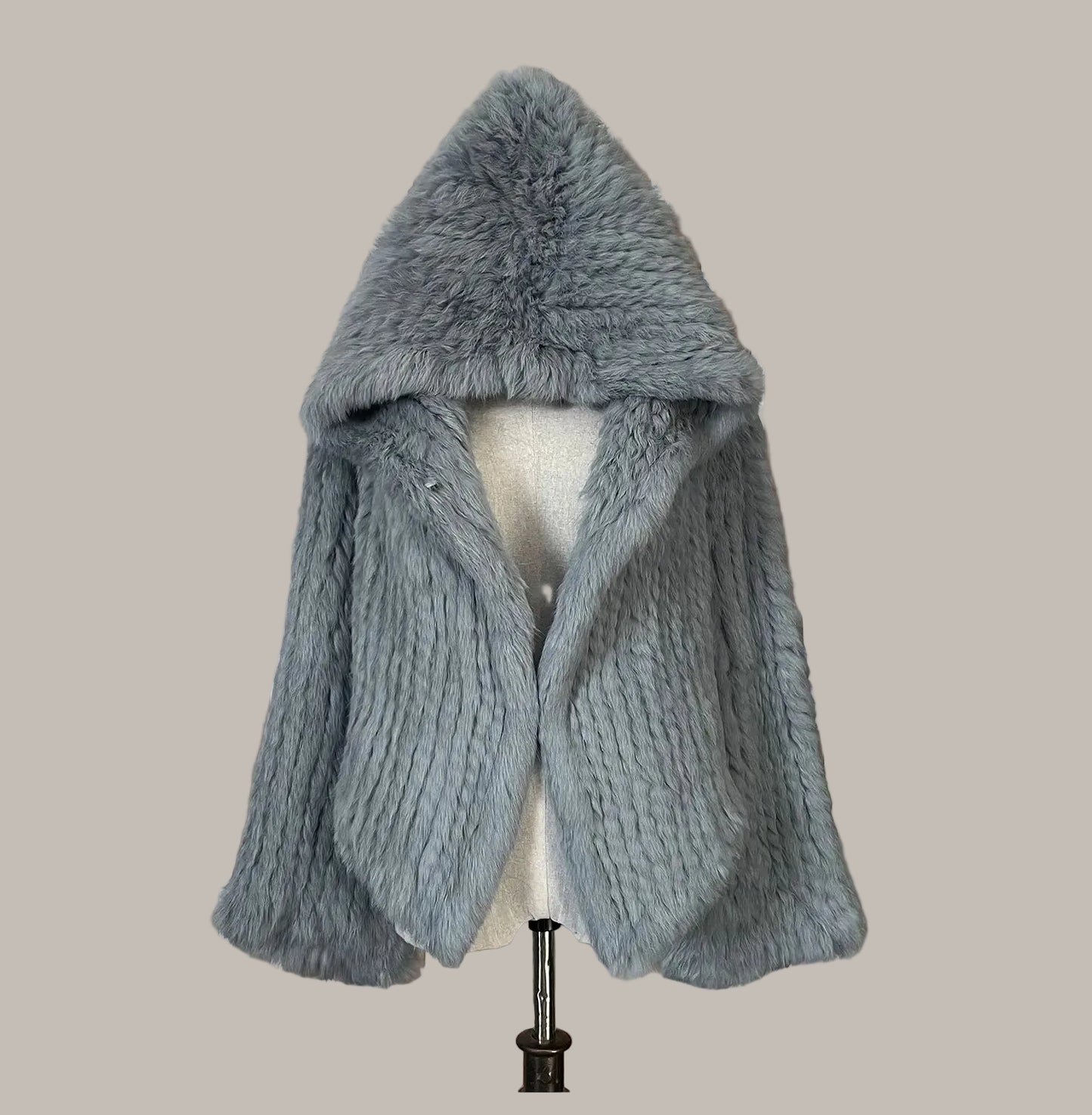 Gray knitted scarf on a mannequin against a decorative background