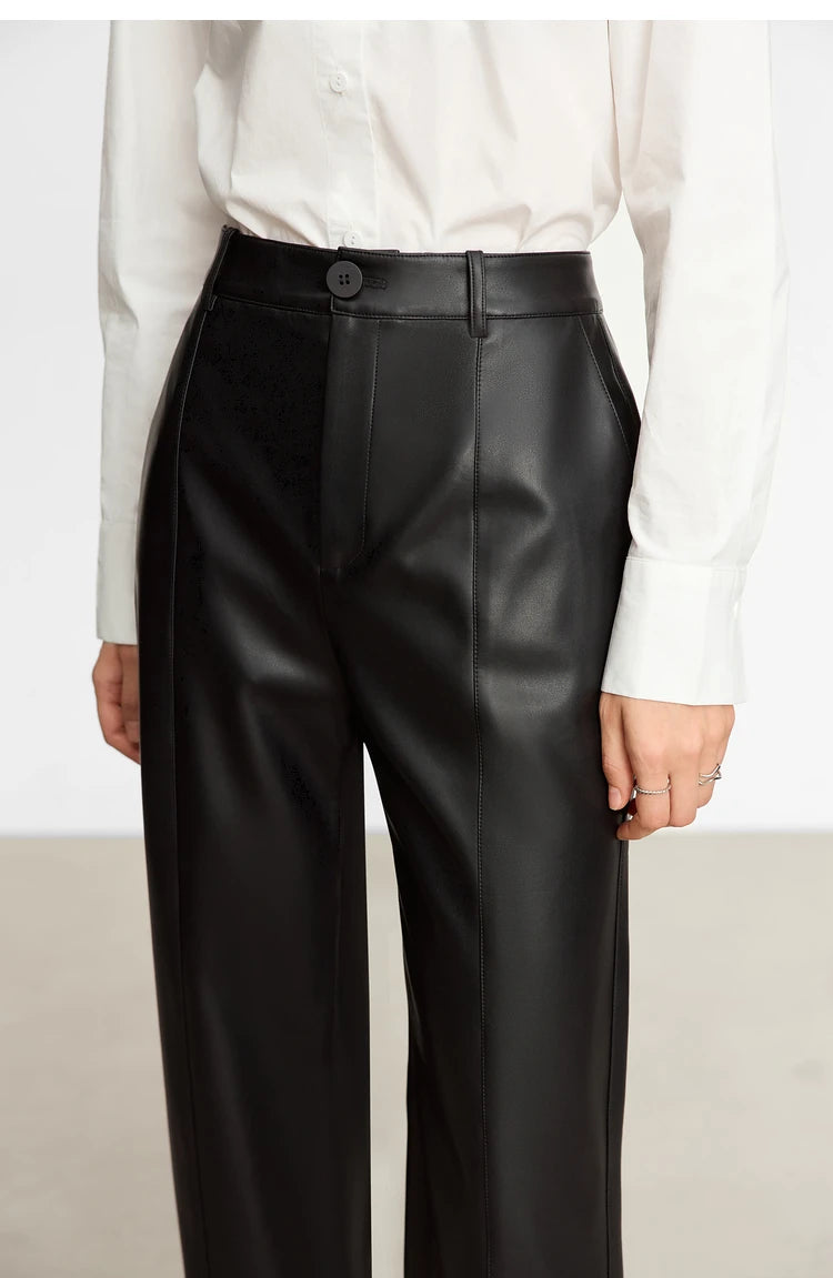 Person wearing black wide-leg pants and a white shirt on a gray background with 'Amii' branding.