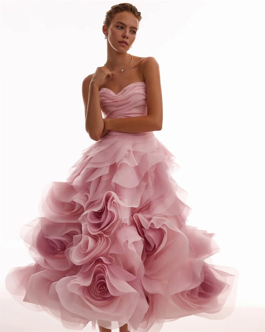 Woman in a pink strapless dress surrounded by handbags on a dark background - HER SHOP