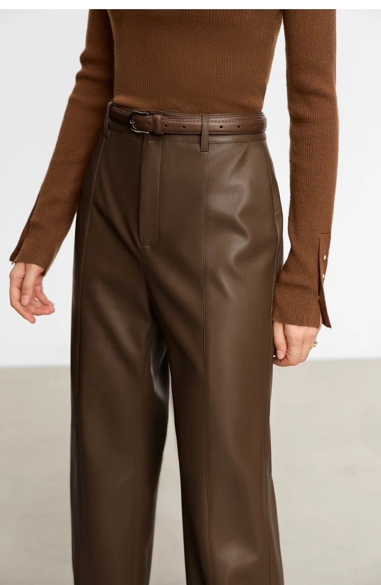 Person wearing black wide-leg pants and a white shirt on a gray background with 'Amii' branding.